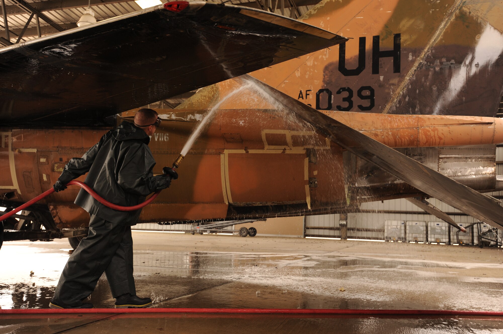 U.S. Air Force Senior Airman Daniel Ricci, 20th Equipment Maintenance Squadron crash recovery, sprays down the F-111E Aardvark at Shaw Air Force Base, S.C., Feb. 8, 2012. Before the Aardvark is displayed with the other historical aircraft at the front gate, it had to be washed and restored. (U.S. Air Force photo by Senior Airman Tabatha McCarthy/Released)