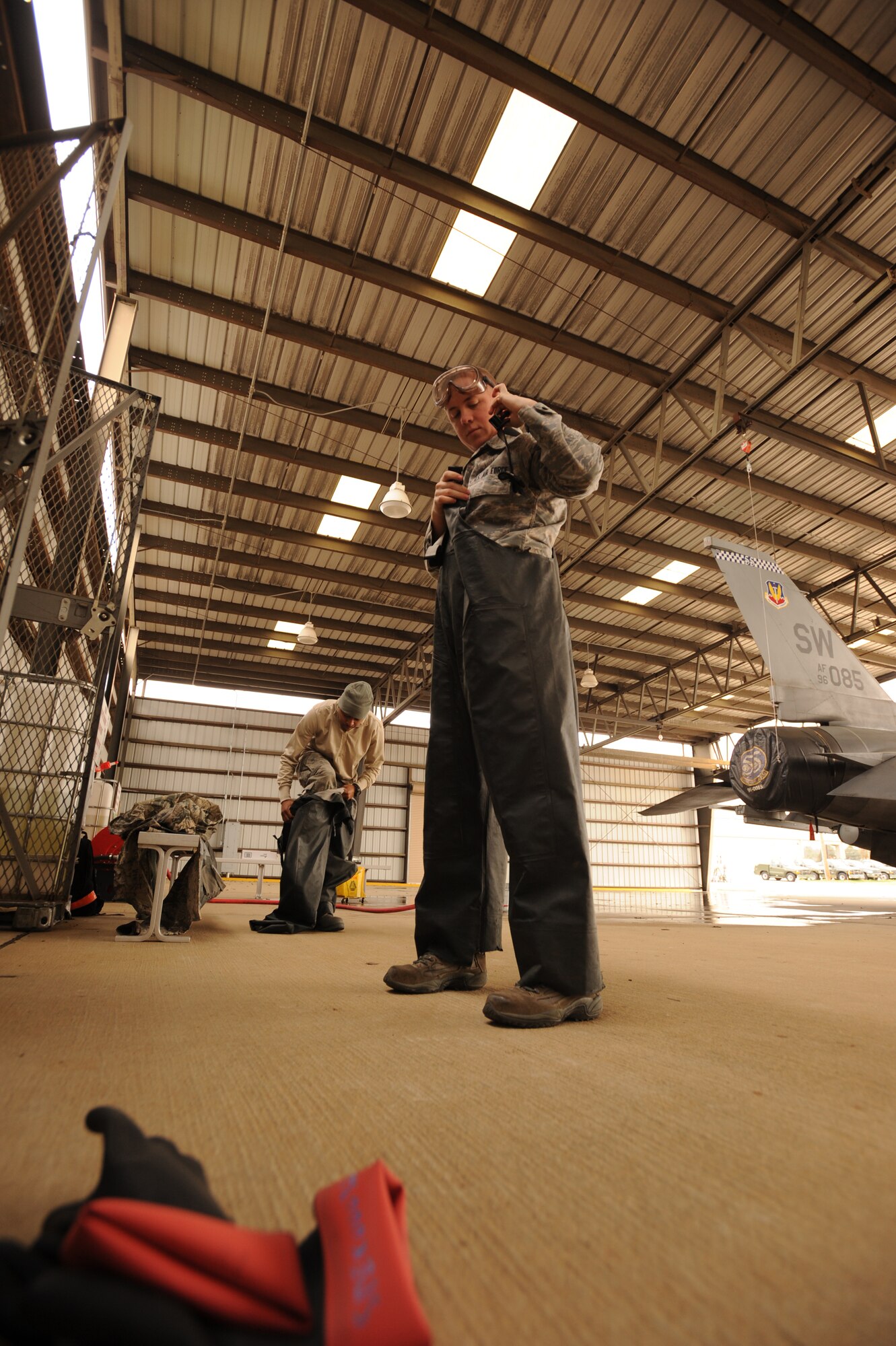 U.S. Air Force Senior Airman Daniel Ricci, 20th Equipment Maintenance Squadron crash recovery, and Airman 1st Class Sherrard Graham, 20th Equipment Maintenance Squadron aircraft structural maintenance, gear up before washing an F-111E Aardvark at Shaw Air Force Base, S.C., Feb. 8, 2012. Before the Aardvark is displayed with the other historical aircraft at the front gate, it had to be washed and restored.  (U.S. Air Force photo by Senior Airman Tabatha McCarthy/Released)