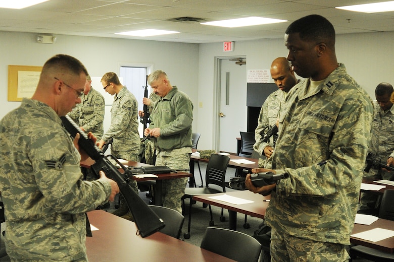 Air Force Senior Airman Josh Buckenberger, 910th Combat Arms Training Maintenence Combat arms instructor, demonstrates weapons safety and familiarization at Youngstown Air Reserve Station, Feb. 5, 2012. Sergeant Buckenberger led the class as part of mandatory Operations Readiness Inspection training. U.S. Air Force photo by Airman 1st Class Ron Dombkowski