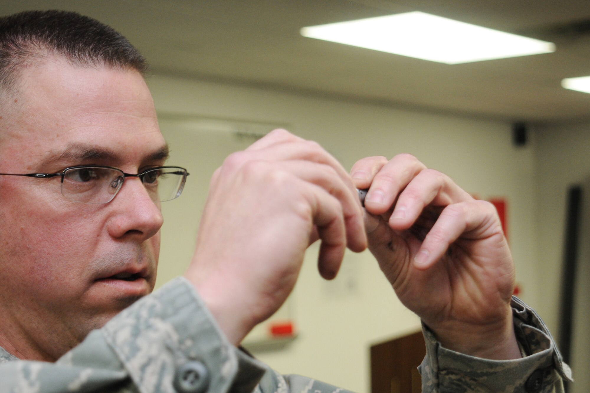 Air Force Senior Airman Josh Buckenberger, 910th Combat Arms Training Maintenence Combat arms instructor, demonstrates weapons safety and familiarization at Youngstown Air Reserve Station, Feb. 5, 2012. Sergeant Buckenberger led the class as part of mandatory Operations Readiness Inspection training. U.S. Air Force photo by Airman 1st Class Ron Dombkowski