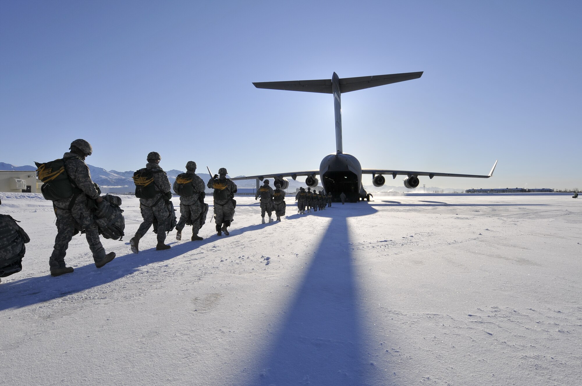 Soldiers assigned to the 6th Engineer Battalion (Combat)(Airborne), Joint Base Elmendorf-Richardson, board a C-17 Globemaster III, Feb. 7. They parachuted from the C-17 over Malemute Drop Zone carrying approximately 135 pounds. (U.S. Air Force photo/Steven White)
