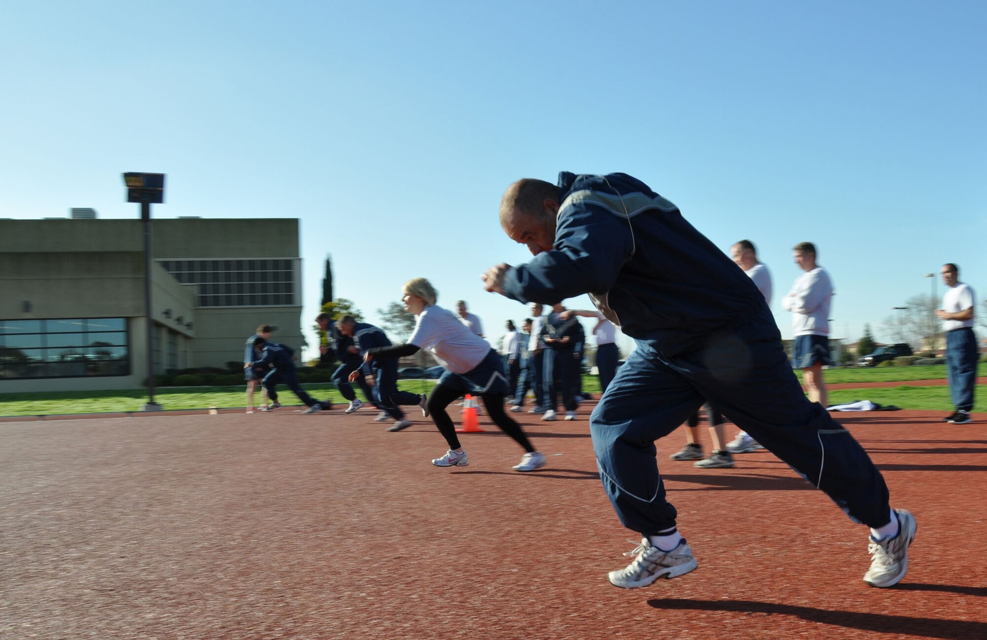 TRAVIS AIR FORCE BASE, Calif. -- Members of the 349th Air Mobility Wing Wing Staff participated in team building event during the A flight Unit Training Assembly on February 12, 2012. The members ran a 3-legged race and relay run, participated in a hula hoop challenge, competed in a softball throw, and raced in a Huffy Green Monster Tri Wheel. (U.S. Air Force photo by Tech Sgt. Rachael Martinez)