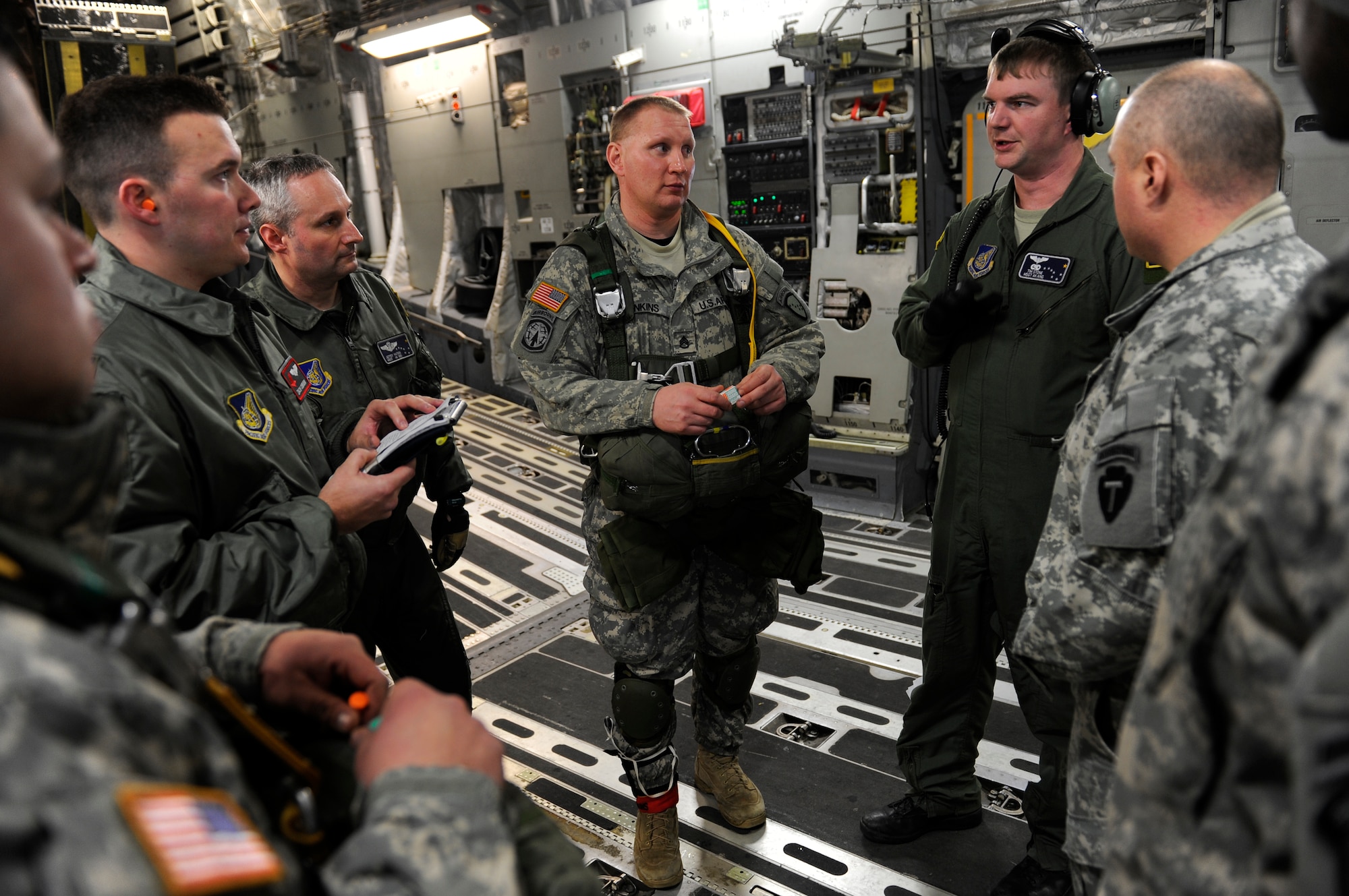 Soldiers and Airmen at Joint Base Elmendorf-Richardson review safety procedures before a personnel air drop from a C-17 Globemaster III from the 517th Airlift Squadron over Malemute Drop Zone, Feb.7. (U.S. Air Force photo/Tech Sgt. Brian Ferguson)
