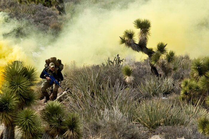 A U.S. Air Force pararescueman, 58th Rescue Squadron, moves toward the location of a simulated casualty during survive, evade, resist, escape initial familiarization training Feb. 14, 2012, near Alamo, Nev. Pararescuemen are required to attend the SERE IFAM, focusing on their navigation skills, as a part of their mission qualification training. (U.S. Air Force photo by Airman 1st Class Daniel Hughes)