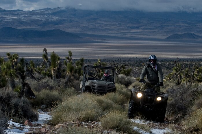 U.S. Air Force Airmen, 58th Rescue Squadron, travel toward a training area during survive, evade, resist, escape initial familiarization training Feb. 14, 2012, near Alamo, Nev. Pararescuemen are required to attend the SERE IFAM, focusing on their navigation skills, as a part of their mission qualification training. (U.S. Air Force photo by Airman 1st Class Daniel Hughes)