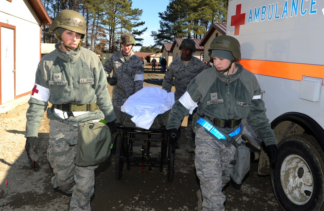 Airmen from the 633rd Medical Group transport a simulated casualty during a phase II operational readiness exercise at Raptor Town at Langley Air Force, Va., Feb. 15, 2012. A phase II ORE is designed to prepare Airmen for deployed operations. (U.S. Air Force photo by Airman 1st Class Racheal Watson/Released)