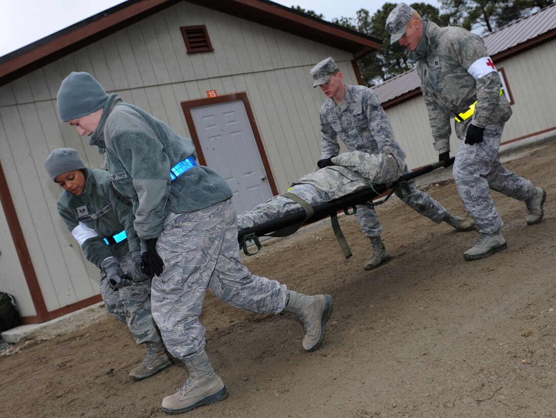 Airmen from the 633rd Medical Group Ambulance Team carry a “victim” after a simulated attack during the phase II operational readiness exercise at Langley Air Force Base, Va., Feb. 14, 2012. The exercise provided training, and prepared Airmen for worldwide deployments. (U.S. Air Force photo by Airman 1st Class Teresa Cleveland/Released)