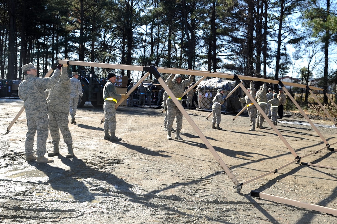 Airmen with the 633rd Medical Operational Squadron build temporary protection tents during an operational readiness exercise at Raptor Town at Langley Air Force Base, Va., Feb. 13, 2012. Airmen prepared for future inspections and exercises in the coming months by assembling the medical tents. (U.S. Air Force photo by Airman 1st Class Racheal Watson/Released)