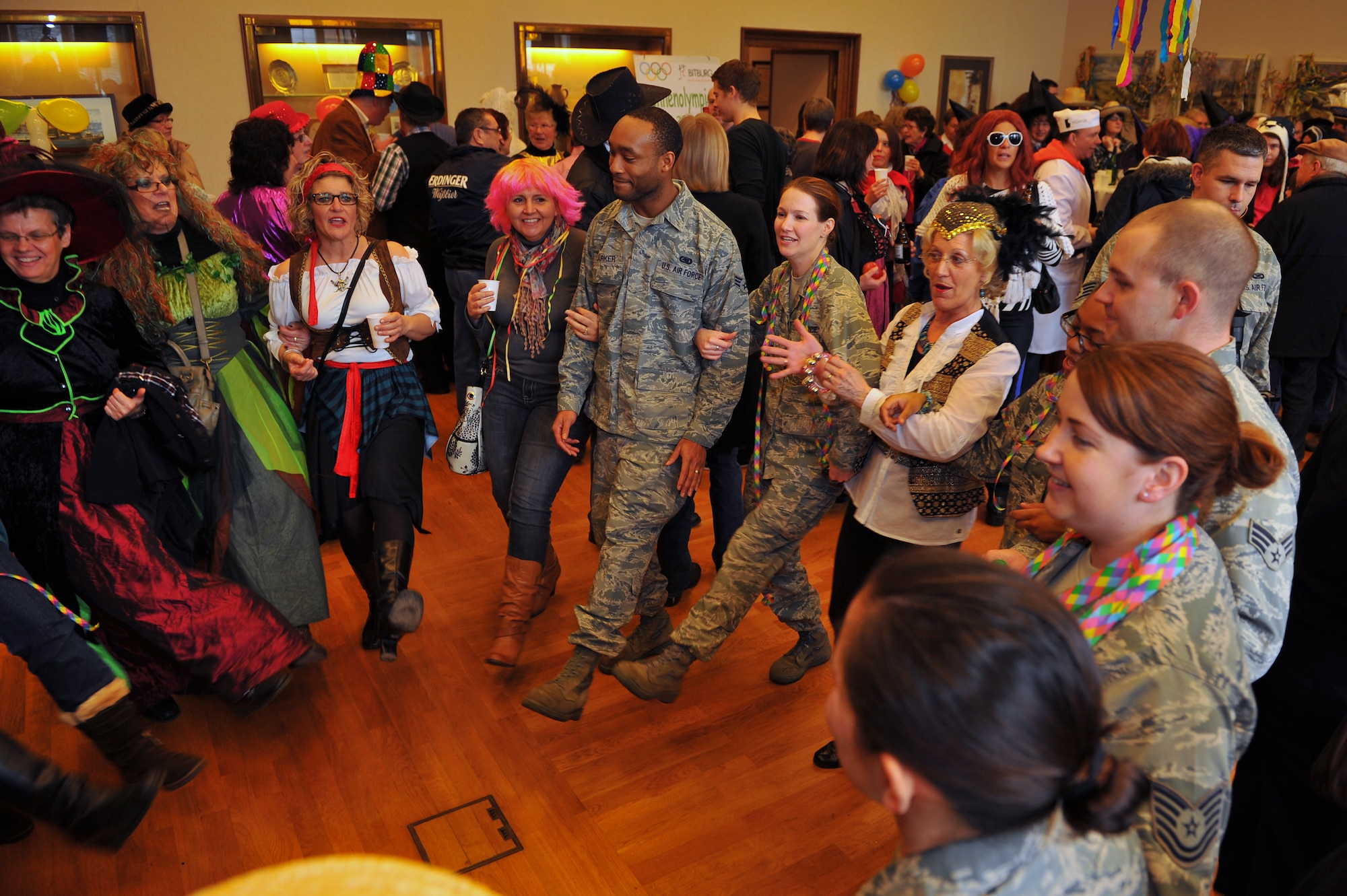 BITBURG, Germany – Local German nationals and Spangdahlem Air Base Airmen dance together during Ladies Fasching Day celebrations at the Bitburg Town Hall here Feb. 16. Ladies Fasching Day is a German celebration where women “take over” the city for the day. Once the ladies have “taken over” the city hall, the celebrations begin with dancing and parading throughout the city. The traditional Fasching celebrations begin the Thursday prior to Lent at the 11th minute past the 11th hour, continue until Ash Wednesday and allow people to indulge before the Lent season. (U.S. Air Force photo by Airman 1st Class Dillon Davis/Released)