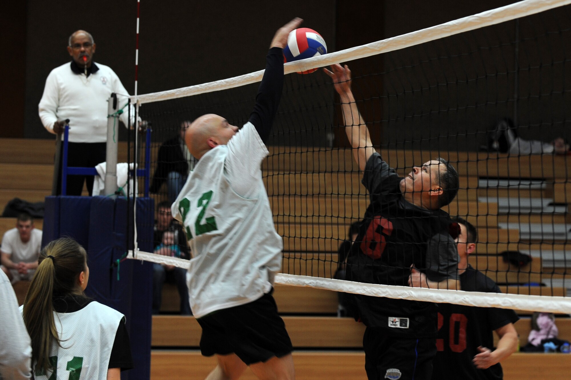 SPANGDAHLEM AIR BASE, Germany – Troy Soeder, 606th Air Control Squadron, number 22, and Jose Murillofierro, 52nd Force Support Squadron, number 6, both go for the the ball during an intramural volleyball game at the Skelton Memorial Fitness Center here Feb. 15. FSS defeated ACS in two sets, 25-16 and 26-24.  This match kicked off the intramural volleyball season, and games will be played Monday – Thursday beginning at 6:30 p.m. at the fitness center. (U.S. Air Force photo by Airman 1st Class Matthew B. Fredericks/Released)