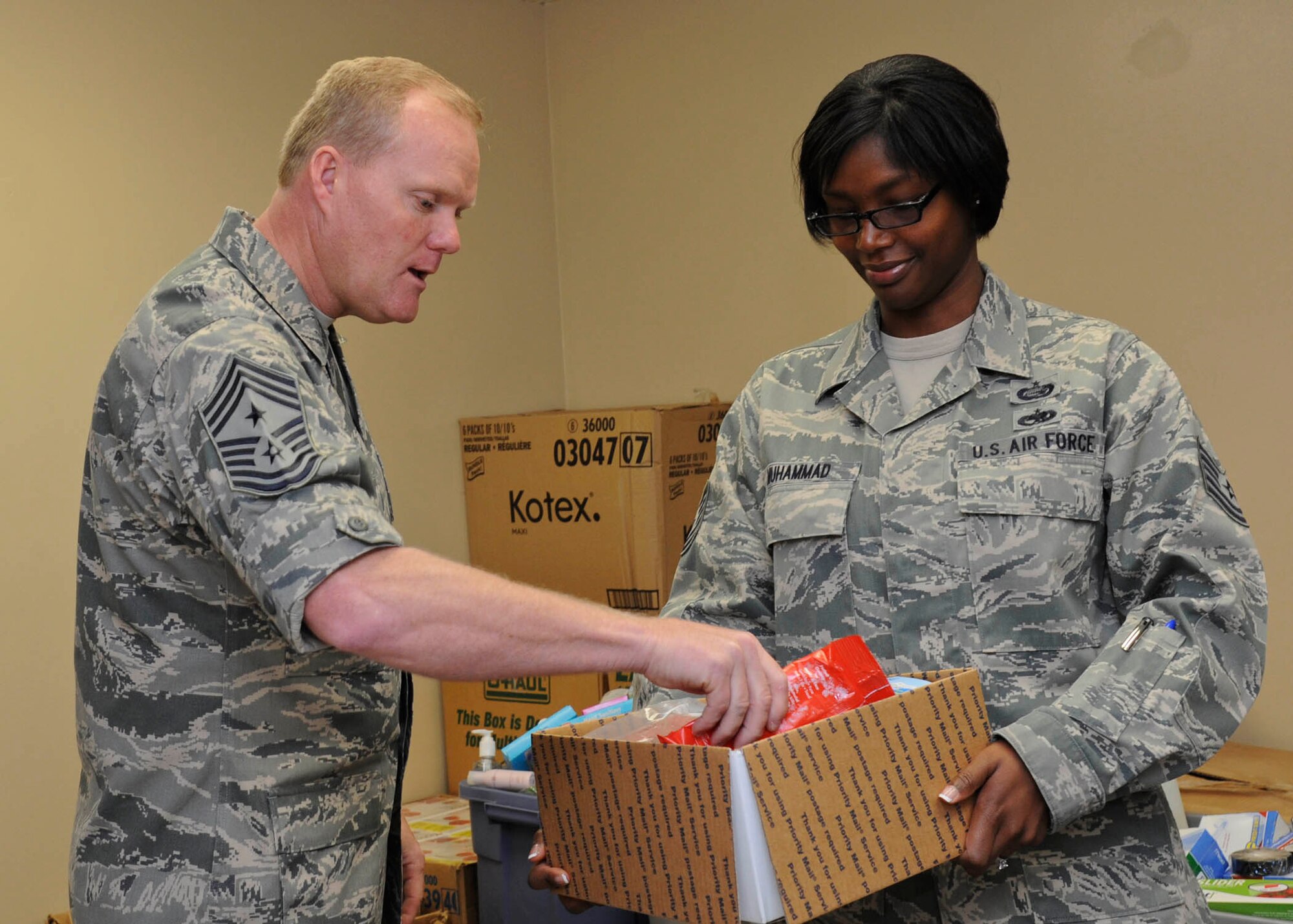 Chief Master Sgt. James Cody, AETC command chief, puts together a care package with Tech. Sgt. Zenobia Muhammad, 56th Maintenance Operation Squadron training scheduler, during his visit to Operation Thunderbox Feb. 10 on Luke Air Force Base. Cody toured various locations on base but primarily came to Luke to attend the 2012 Chief Recognition ceremony.  (U.S. Air Force photo by Staff Sgt. Darlene Seltmann)