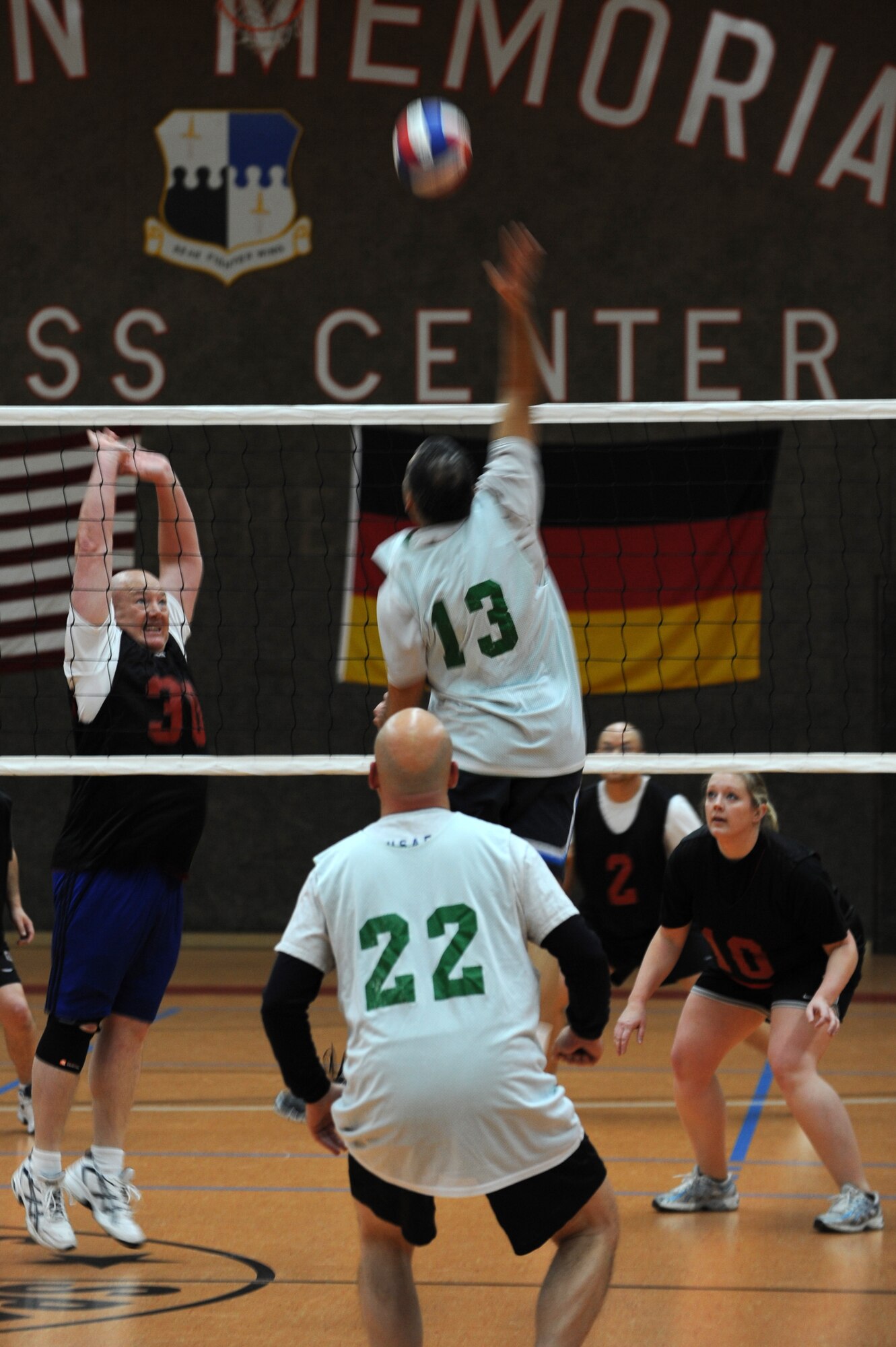 SPANGDAHLEM AIR BASE, Germany – Steven Wilson, 52nd Force Support Squadron, number 30, goes up to block a volleyball spiked by Jose Becerra, 606th Air Control Squadron, number 13, during an intramural volleyball game at the Skelton Memorial Fitness Center here Feb. 15. FSS defeated ACS in two sets, 25-16 and 26-24.  This match kicked off the intramural volleyball season, and games will be played Monday – Thursday beginning at 6:30 p.m. at the fitness center. (U.S. Air Force photo by Airman 1st Class Matthew B. Fredericks/Released)