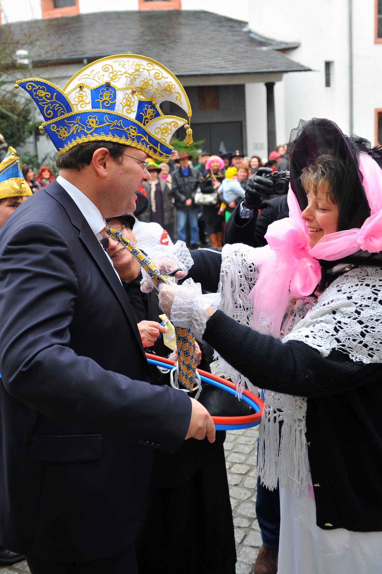 BITBURG, Germany – A Fasching participant cuts the tie of Joachim Kandels, Bitburg mayor, as tradition dictates during Ladies Fasching Day celebrations at the Bitburg Town Hall here Feb. 16. Ladies Fasching Day is a German celebration where women “take over” the city for the day. Once the ladies have “taken over” the city hall, the celebrations begin with dancing and parading throughout the city. The traditional Fasching celebrations begin the Thursday prior to Lent at the 11th minute past the 11th hour, continue until Ash Wednesday and allow people to indulge before the Lent season. (U.S. Air Force photo by Airman 1st Class Dillon Davis/Released)