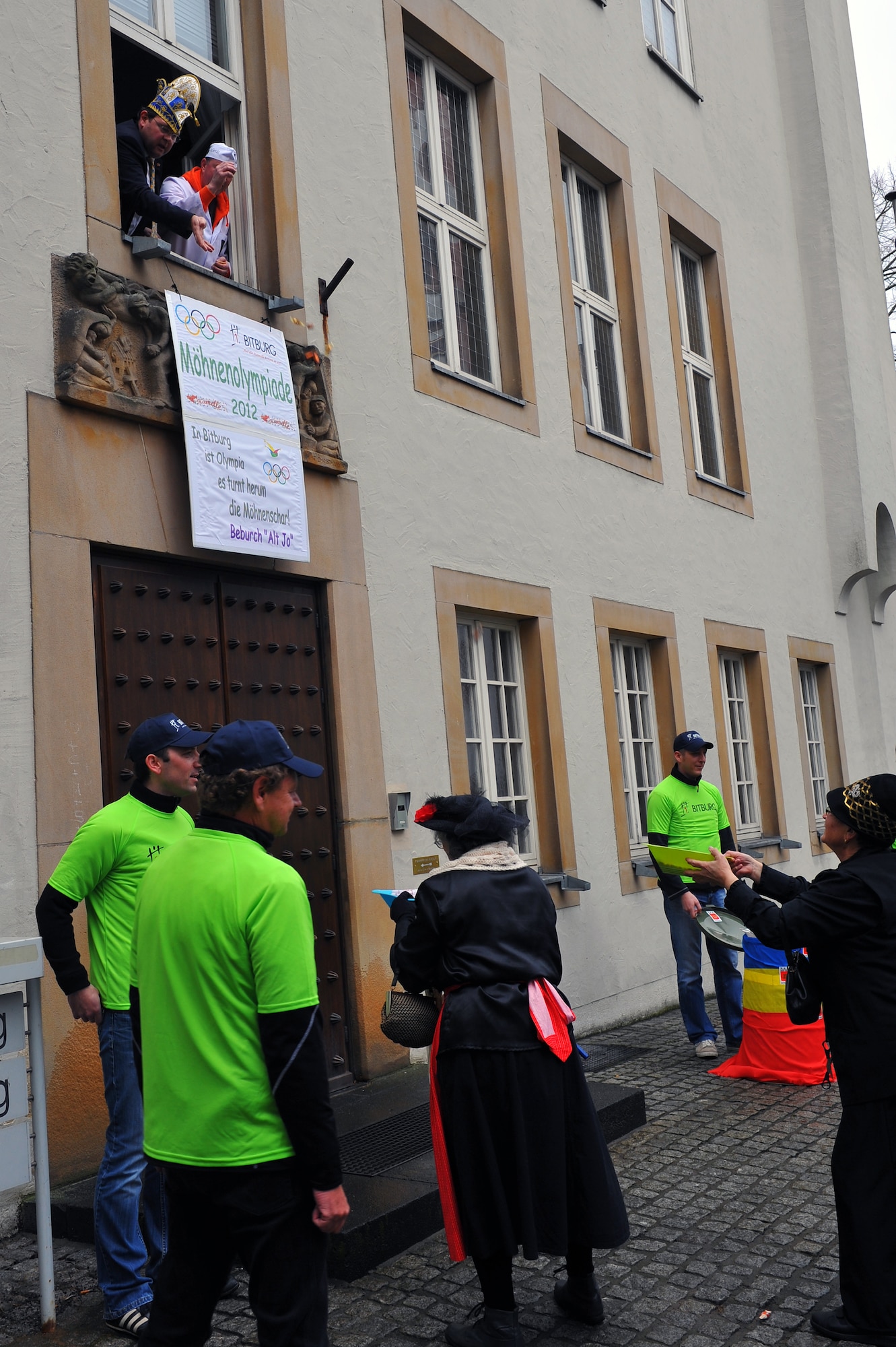 BITBURG, Germany – Joachim Kandels, Bitburg mayor, tosses candy out of a window to people below during Ladies Fasching Day celebrations at the Bitburg Town Hall here Feb. 16. Ladies Fasching Day is a German celebration where women “take over” the city for the day. Once the ladies have “taken over” the city hall, the celebrations begin with dancing and parading throughout the city. The traditional Fasching celebrations begin the Thursday prior to Lent at the 11th minute past the 11th hour, continue until Ash Wednesday and allow people to indulge before the Lent season. (U.S. Air Force photo by Airman 1st Class Dillon Davis/Released)