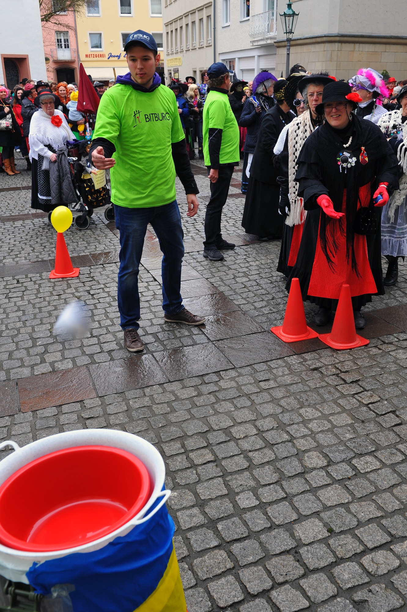 BITBURG, Germany – A Fasching participant tosses a beanbag into a bucket as part of an obstacle course during Ladies Fasching Day celebrations at the Bitburg Town Hall here Feb. 16. Ladies Fasching Day is a German celebration where women “take over” the city for the day. Once the ladies have “taken over” the city hall, the celebrations begin with dancing and parading throughout the city. The traditional Fasching celebrations begin the Thursday prior to Lent at the 11th minute past the 11th hour, continue until Ash Wednesday and allow people to indulge before the Lent season. (U.S. Air Force photo by Airman 1st Class Dillon Davis/Released)
