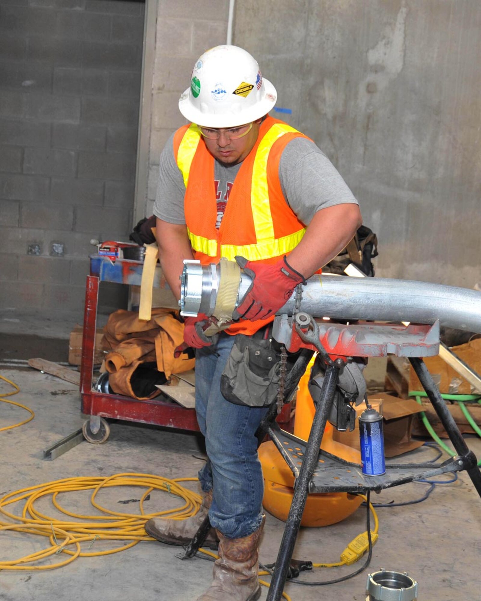 Jesse Gomez, a contract employee working to finish the 37th Training Wing's new Airman Training Complex No. 1, installs a coupler on a piece of conduit Feb. 7 at the Airman Training Complex No. 1 construction site. The complex is tentatively scheduled for completion in late summer. (U.S. Air Force photo/Alan Boedeker)