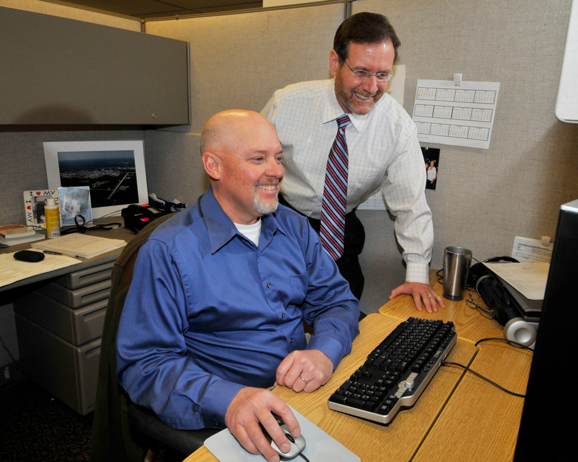 Marty Gordon (left), an Aerospace Testing Alliance (ATA) software engineer, earned an Ideas in Action Suggestion Program cash award in December by helping discover a $23,548 cost avoidance for Arnold Engineering Development Center (AEDC). The savings came about as part of transitioning a computer software application from a two-server configuration to a virtual server. Also pictured is Mark Rigney, director of Information Technology and Systems (IT&S) for ATA. (Photo by Rick Goodfriend)