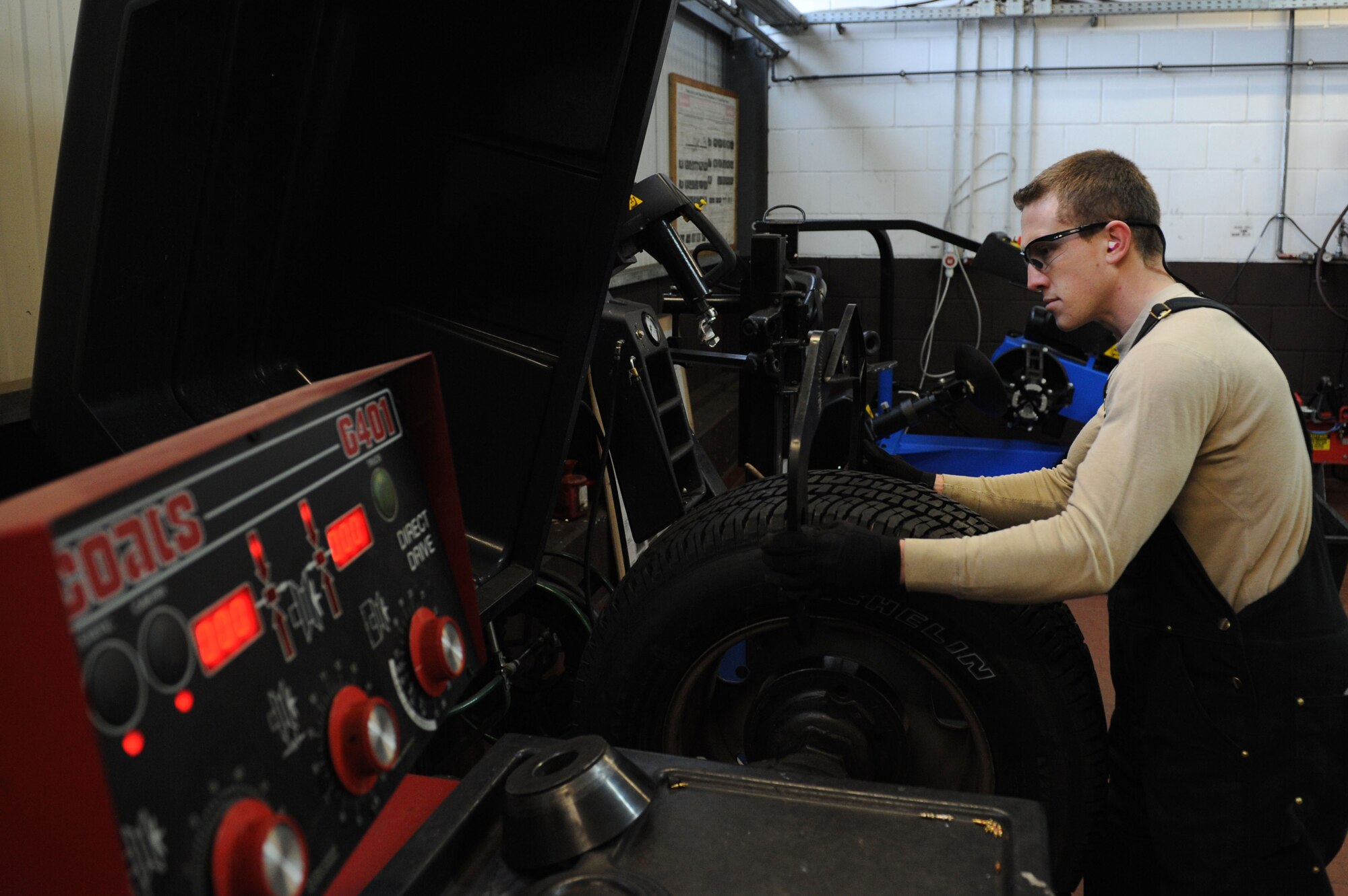 SPANGDAHLEM AIR BASE, Germany – Senior Airman Brandon Adams, 52nd Logistics Readiness Squadron vehicle maintenance journeyman, measures the width of a tire rim to program into the balancing machine during a mounting process at the tire shop in Bldg. 111 here Feb. 15. The process allows the issuing of new tires to government-owned vehicles keeping the vehicle safe and serviceable. The vehicle management flight continuously services and maintains more than 900 government-owned vehicles for Spangdahlem, Bitburg and all the geographically - separated units. (U.S. Air Force photo by Senior Airman Christopher Toon/Released)