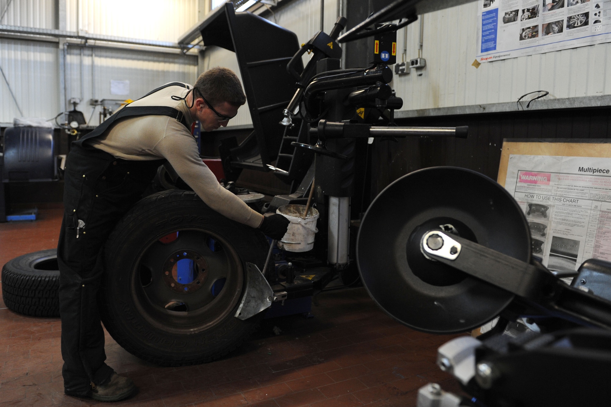 SPANGDAHLEM AIR BASE, Germany – Senior Airman Brandon Adams, 52nd Logistics Readiness Squadron vehicle maintenance journeyman, breaks a tire seal during a tire demounting process at the tire shop in Bldg. 111 here Feb. 15. The process allows the issuing of new tires to government-owned vehicles keeping the vehicle safe and serviceable. The vehicle management flight continuously services and maintains more than 900 government-owned vehicles for Spangdahlem, Bitburg and all the geographically - separated units. (U.S. Air Force photo by Senior Airman Christopher Toon/Released)