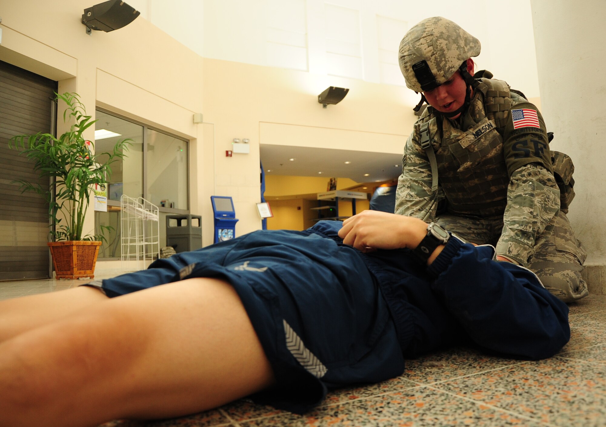 Senior Airman Catherine Nelson, 379th Expeditionary Security Forces Squadron ground defense specialist and Ava, Mo. native, performs first aid on a simulated victim in the Blatchford-Preston Complex Mall during an active shooter exercise Feb. 14, 2012. The exercise tested the defense and response capabilities of U.S. service members and coalition partners on the installation. Nelson is deployed from McConnell Air Force Base, Kan. (U.S. Air Force photo/Senior Airman Michael Charles)