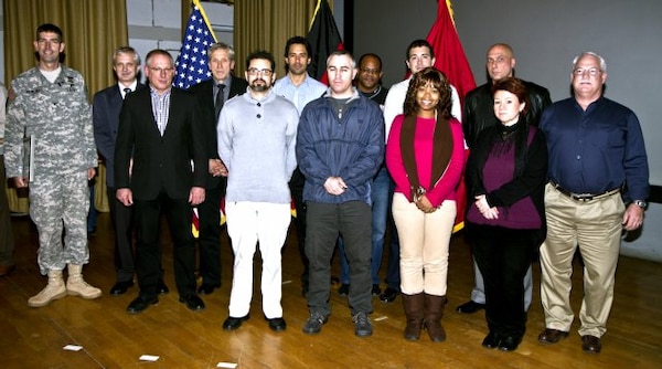 WIESBADEN, Germany — The U.S. Army Corps of Engineers Europe District Grafenwoehr Environmental Project Delivery Team receives a Certificate of Achievement from Col. D. Peter Helmlinger (far left), district commander, for the exceptional execution of 20 projects and more than $40 million in fiscal year 2011 during the district Town Hall  at the Taunus Theater here, Nov. 18, 2011.