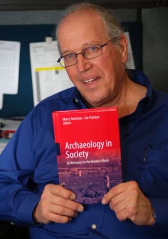 SACRAMENTO, Calif. — Richard Perry, archaeologist with the U.S. Army Corps of Engineers Sacramento District, poses here, Feb. 15, 2012 with the recently published book, "Archaeology in Society". Perry's study of prehistoric and historic sites at a former target range at Honey Lake, Calif., is featured in the book.