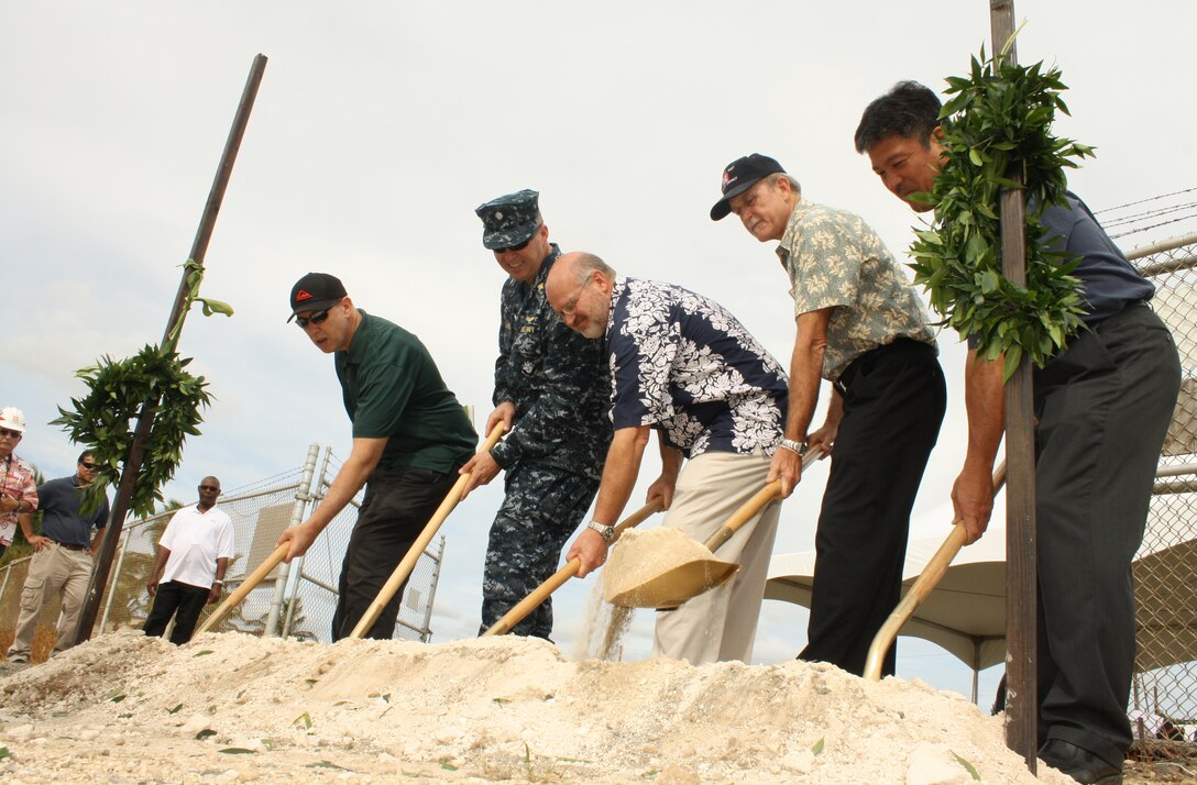 U.S. Army Corps of Engineers Area Engineer Tim Phillips, left, U.S. Navy Fleet Logistics Center Operations Officer Cdr. David Laramie, Reliable Contracting Group Project Manager Mark Keeling, U.S. Army Corps of Engineers Chief of Engineering and Construction Todd Barnes, and Defense Logistics Agency Project Manager Wesley Hirano turn the soil during the traditional untying of the Maile Lei and Ground Breaking Ceremony held Wednesday for the FY11 Alter Fuel Storage Tanks project at Area 11, Joint Base Pearl Harbor-Hickam (JBPHH).  The ceremony was presided over by Reverend David Ka’upu. 