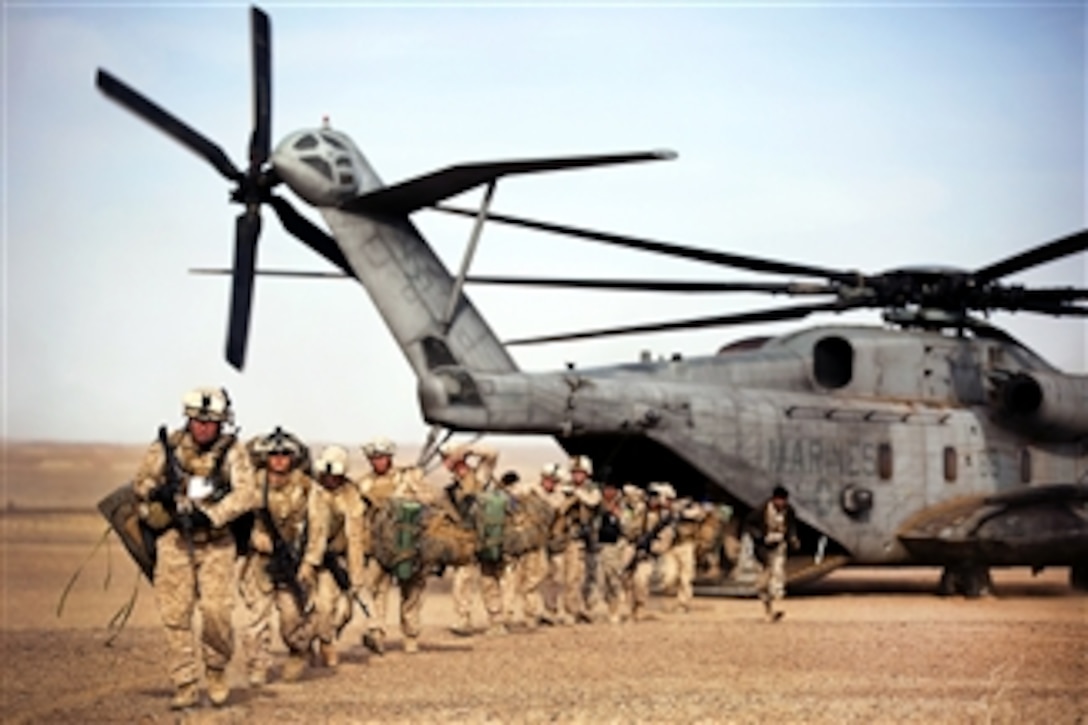 U.S. Marines and Afghan border police off-load from a CH-53D Sea Stallion helicopter during Operation Shahem Tofan Eagle Storm in the Garmsir district, Helmand province, Afghanistan, on Feb. 10, 2012.  The Marines are assigned to Weapons Company, 3rd Battalion, 3rd Marine Regiment.  