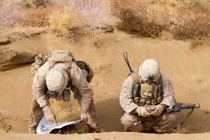 U.S. Marine Sgt. Jared Carlson (left), a squad leader with Alpha Company, 1st Light Armored Reconnaissance Battalion and 26-year-old native of Kaneohe, Hawaii, and Sgt. Mario Mendoza, a team leader with Alpha Company, 1st Light Armored Reconnaissance Battalion, and 25-year-old native of Seguin, Texas, plot the location of a compound on a map during a patrol here, Feb. 16. Marines and sailors with 1st LAR and India Company, 3rd Battalion, 3rd Marine Regiment, conducted clearing and disrupting operations in and around the villages of Sre Kala and Paygel during Operation Highland Thunder. Marines with 1st LAR led the operation on foot, sweeping for enemy weapons and drug caches through 324 square kilometers of rough, previously unoccupied desert and marshland terrain. Mobile units with1st LAR set up blocking positions and vehicle check points while India Company, 3/3 conducted helicopter inserts to disrupt insurgent freedom of movement.