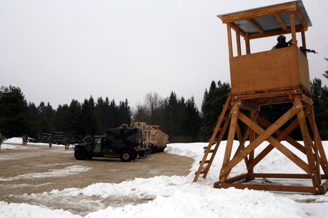 Two Georgian soldiers from Alpha Company, Georgian 23rd Light Infantry Battalion remain vigilant from the top of a watchtower immediately after the unit’s combat outpost (COP) was attacked by enemy insurgents (Portrayed by U.S. Army soldiers from 1st Battalion, 4th Infantry Regiment) using indirect and scout sniper fire during part of a mission rehearsal exercise at Joint Multinational Readiness Center Hohenfels, Germany, Feb. 18. The 23rd Georgian Light Infantry Battalion is preparing to support counterinsurgency operations in Afghanistan as part of Georgia Deployment Program - International Security Assistance Force.
