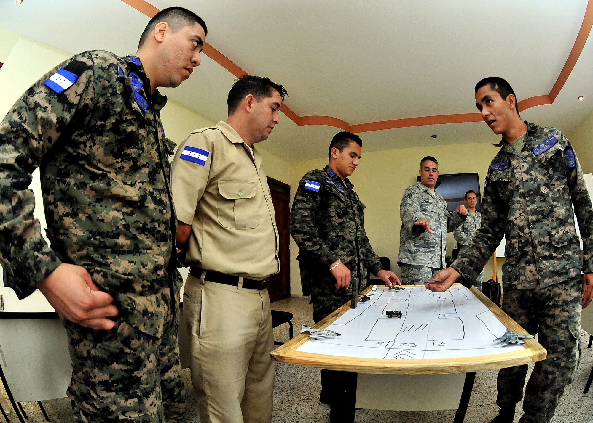 Tech. Sgt. Aaron Carrillo, 571st Mobility Support Advisory Squadron air traffic control air advisor, discusses "go-around procedures" with the Honduran Air Force ATC controllers during the third block of the ATC seminar Feb. 13, as part of month-long Building Partner Capacity mission.  A go-around is an aborted landing of an aircraft that is on final approach.  (U.S. Air Force photo by Tech. Sgt. Lesley Waters)