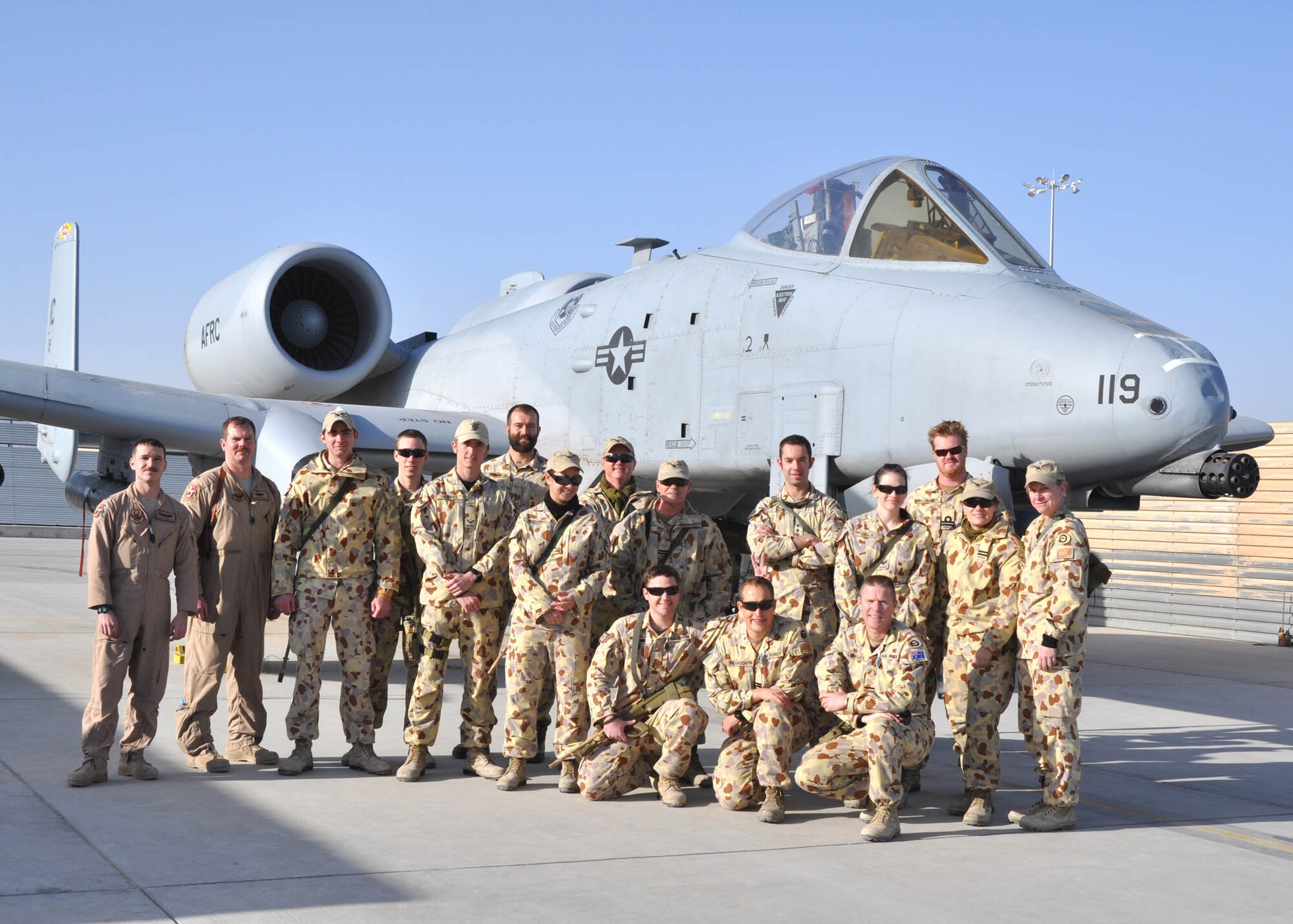 Members of the 303rd Expeditionary Fighter Squadron and Royal Australian air force pose in front of an A-10 Thunderbolt II at Kandahar Airfield, Afghanistan Feb. 14, 2012.  The RAAF members fly the Israel Aerospace Industries’ Heron unmanned aerial vehicles out of Kandahar Airfield..  (U.S. Air Force photo by Capt. Passion Julinsey)