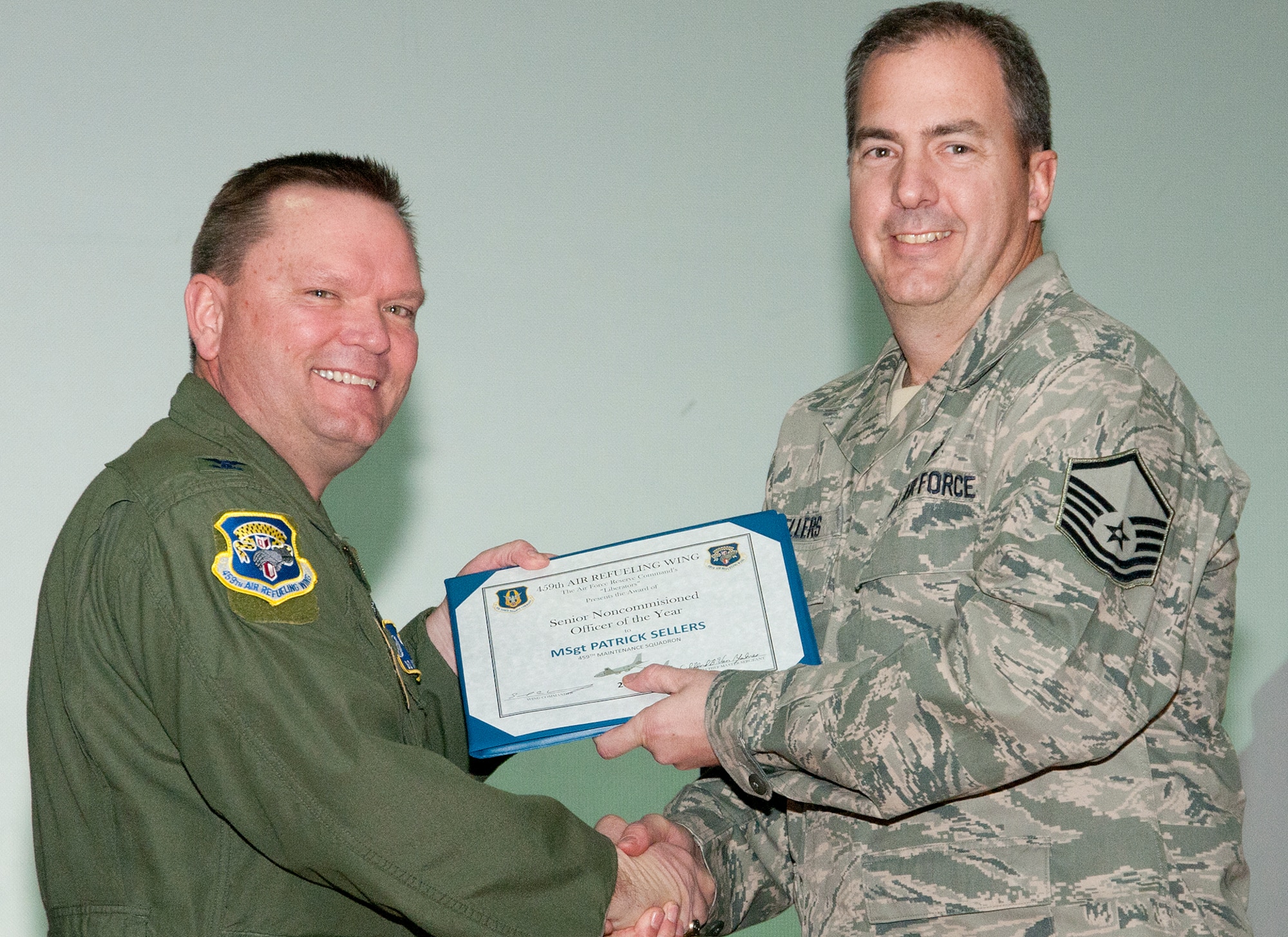 JOINT BASE ANDREWS, Md. -- Col. Samuel Mahaney, 459th Air Refueling Wing commander, congratulates Master Sgt. Patrick Sellers, 459th Maintenance Squadron, for being awarded 459th ARW Senior Noncomissioned Officer of the Second Half 2011 during a commander's call here Feb. 12, 2012. (U.S. Air Force photo/Staff Sgt. Brent Skeen)