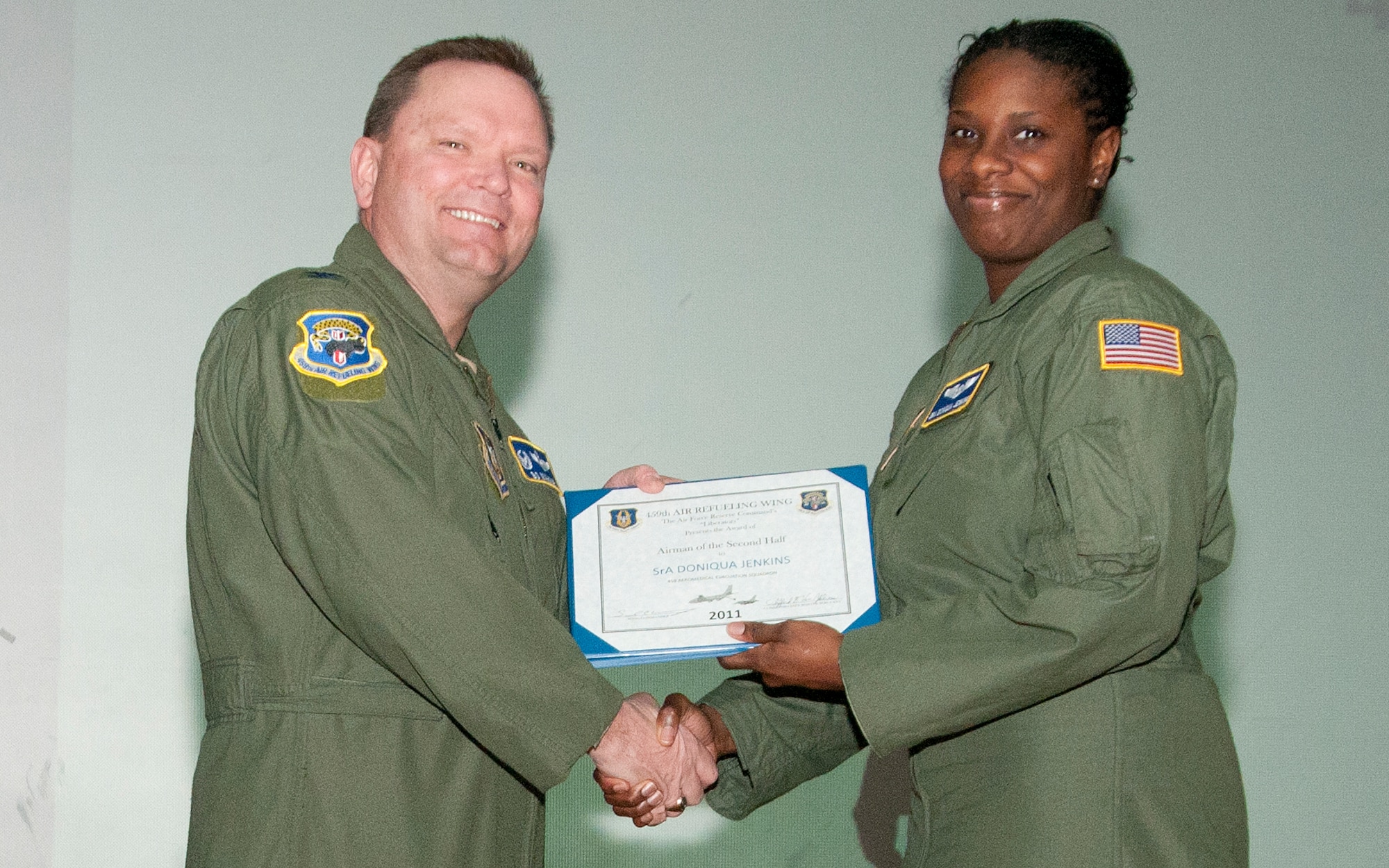 JOINT BASE ANDREWS, Md. -- Col. Samuel Mahaney, 459th Air Refueling Wing commander, congratulates Senior Airman Doniqua Jenkins, 459th Aeromedical Evacuation Squadron, for being awarded 459th ARW Airman of the Second Half 2011 during a commander's call here Feb. 12, 2012. (U.S. Air Force photo/Staff Sgt. Brent Skeen)