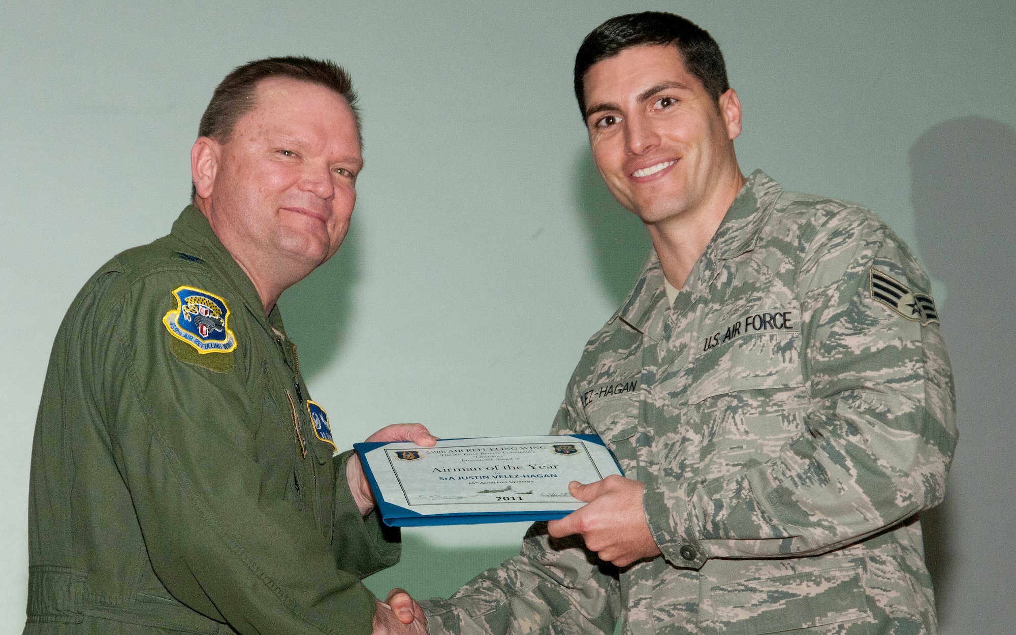 JOINT BASE ANDREWS, Md. -- Col. Samuel Mahaney, 459th Air Refueling Wing commander, congratulates Senior Airman Justin Velez-Hagan, 69th Aerial Port Squadron, for being awarded 459th ARW Airman of the Year for 2011 during a commander's call here Feb. 12, 2012. (U.S. Air Force photo/Staff Sgt. Brent Skeen)