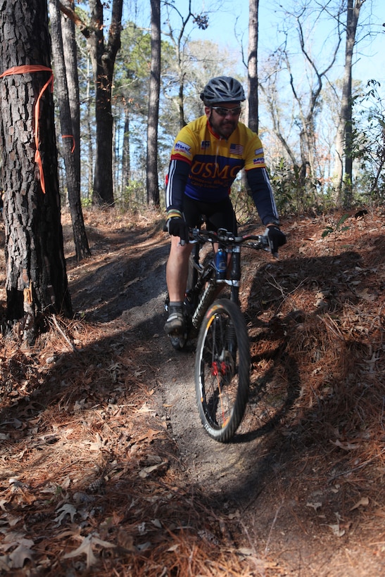 Jeff LeBlanc, the mountain bike coordinator with DEC, and retired master gunnery sergeant, rides his bike on the off-road trails near Henderson Pond aboard MCB Camp Lejeune, Feb. 20. There volunteer work force completed the first 3 mile-long loop, which is now open for patrons to use.