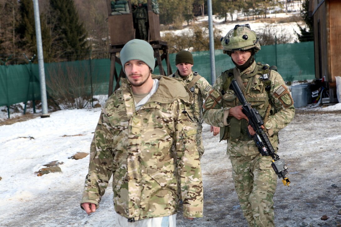 A Georgian soldier from Charlie Company, 23rd Light Infantry Battalion escorts a suspected insurgent, who was apprehended during a cordon and search operation, during a mission rehearsal exercise at Joint Multinational Readiness Center Hohenfels, Germany, Feb. 20. The 23rd Georgian Light Infantry Battalion is preparing to support counterinsurgency operations in Afghanistan as part of Georgia Deployment Program - International Security Assistance Force.