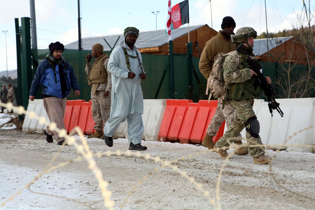 A squad of Georgian soldiers from Charlie Company, 23rd Light Infantry Battalion escort recently released suspected insurgent from the unit's combat outpost. These suspects were apprehended during a cordon and search operation, during a mission rehearsal exercise at Joint Multinational Readiness Center Hohenfels, Germany, Feb. 20. The 23rd Georgian Light Infantry Battalion is preparing to support counterinsurgency operations in Afghanistan as part of Georgia Deployment Program - International Security Assistance Force.
