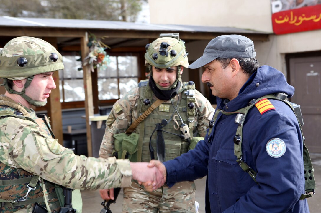 Georgian soldiers from Charlie Company, 23rd Light Infantry Battalion meet up with local authorities to discuss the unit’s earlier operation and the villager’s overall reaction and sentiments in regards to the events transpired during a  mission rehearsal exercise at Joint Multinational Readiness Center Hohenfels, Germany, Feb. 20. The 23rd Georgian Light Infantry Battalion is preparing to support counterinsurgency operations in Afghanistan as part of Georgia Deployment Program - International Security Assistance Force.