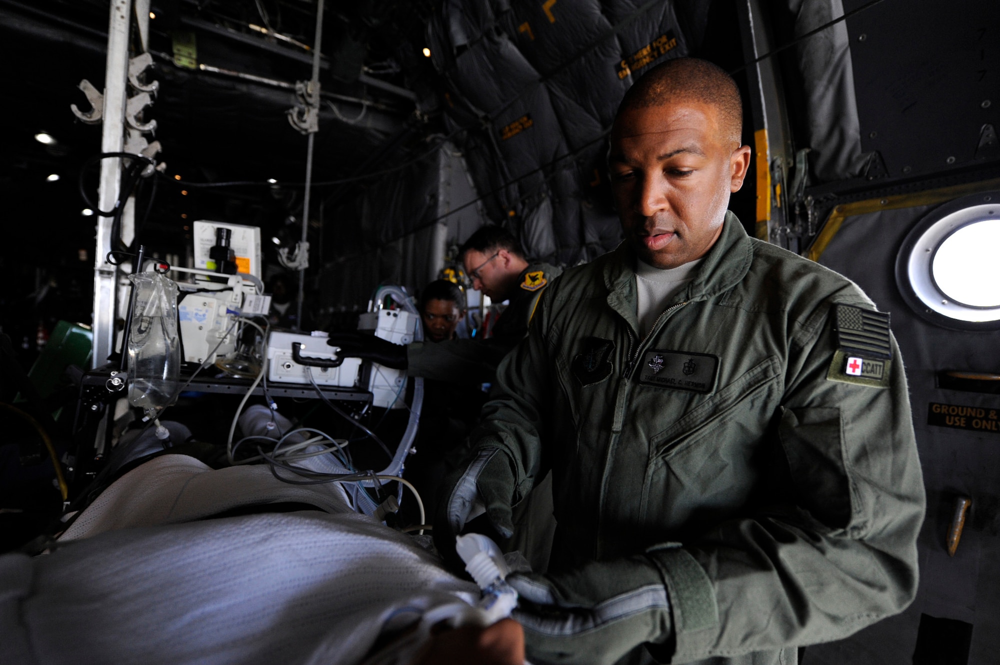 U.S. Air Force Tech. Sgt. Michael Hermon, respiratory therapist, adjusts a breathing tube on a manikin during a routine training mission on a U.S. Air Force C-130 Hercules aircraft on Kadena Air Base, Japan, Feb. 14, 2012. Hermon is part of the Pacific Air Forces Critical Care Air Transport Team assigned to the 18th Medical Group. The CCATT provides care to critically ill or injured patients with multi-systems, trauma, shock, burns, respiratory failure, multiple organ failure, or other life threatening complications. (U.S. Air Force photo by James M. Bowman/Released)
