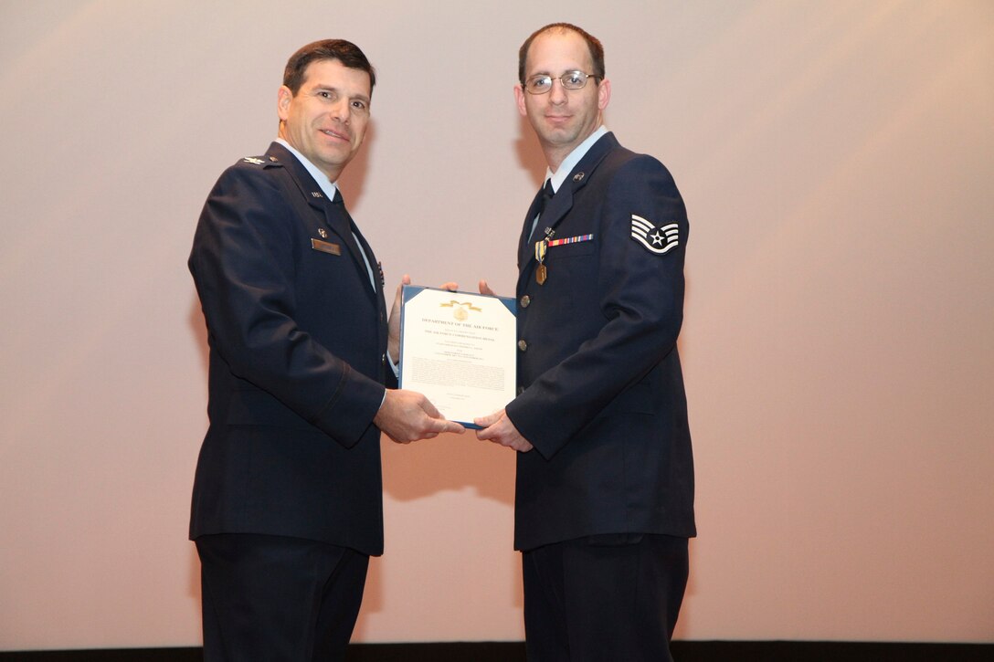 Staff Sgt. Jeff Smith, 932nd Staff Judge Advocate's Office, receives the Air Force Commendation Medal from Col. Albert Lupenski, 932nd Airlift Wing commander Feb. 12, 2012. (U.S. Air Force photo/Tech. Sgt. Christopher Parr)