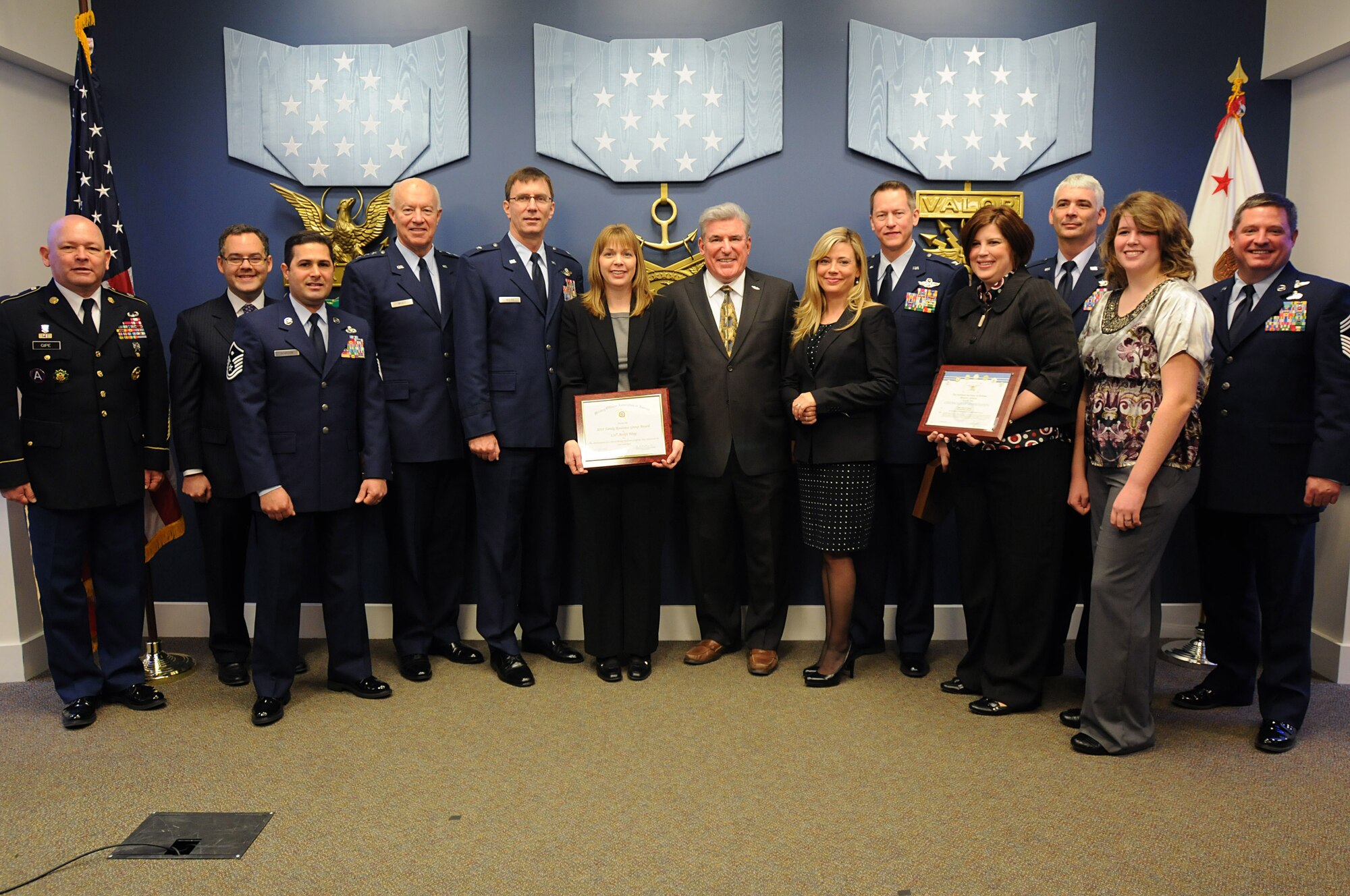 Air Force Lt. Gen. Harry Wyatt, director of the Air National Guard (middle left), stands with Airmen from the 136th Airlift Wing, Texas National Guard, and unit Family Readiness Group members, during the 2012 Department of Defense Reserve Family Readiness Awards ceremony at the Pentagon Feb. 17, 2012. The 136th was recognized as having the top Air Guard FRG program. (Photo by Army National Guard Sgt. Darron Salzer)