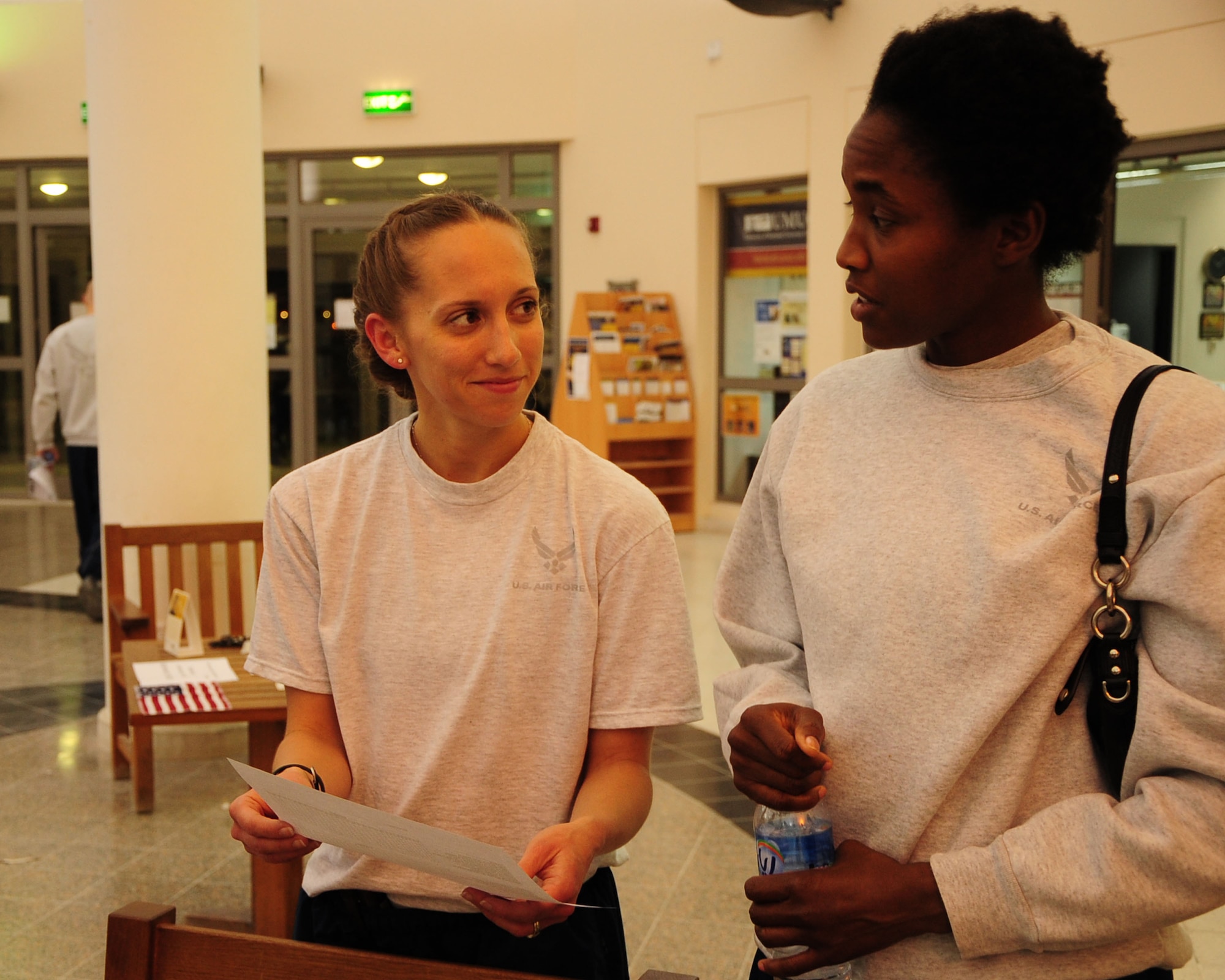 1st Lt. Pauline Smith, 379th Air Expeditionary Wing protocol officer and Dallas native, receives information on resilience programs from Tech. Sgt. Tamra Whiting, 379th Expeditionary Medical Group  radiology specialist and victory chapel volunteer, during the relationship building seminar and information fair at the Blatchford-Preston Mall here Feb. 14, 2012. The wing chaplain’s office sponsored the event to strengthen family relationships and offer information on programs for service members and their families to coping with the stresses of being deployed. (U.S Air Force photo/ Senior Airman Michael Charles)