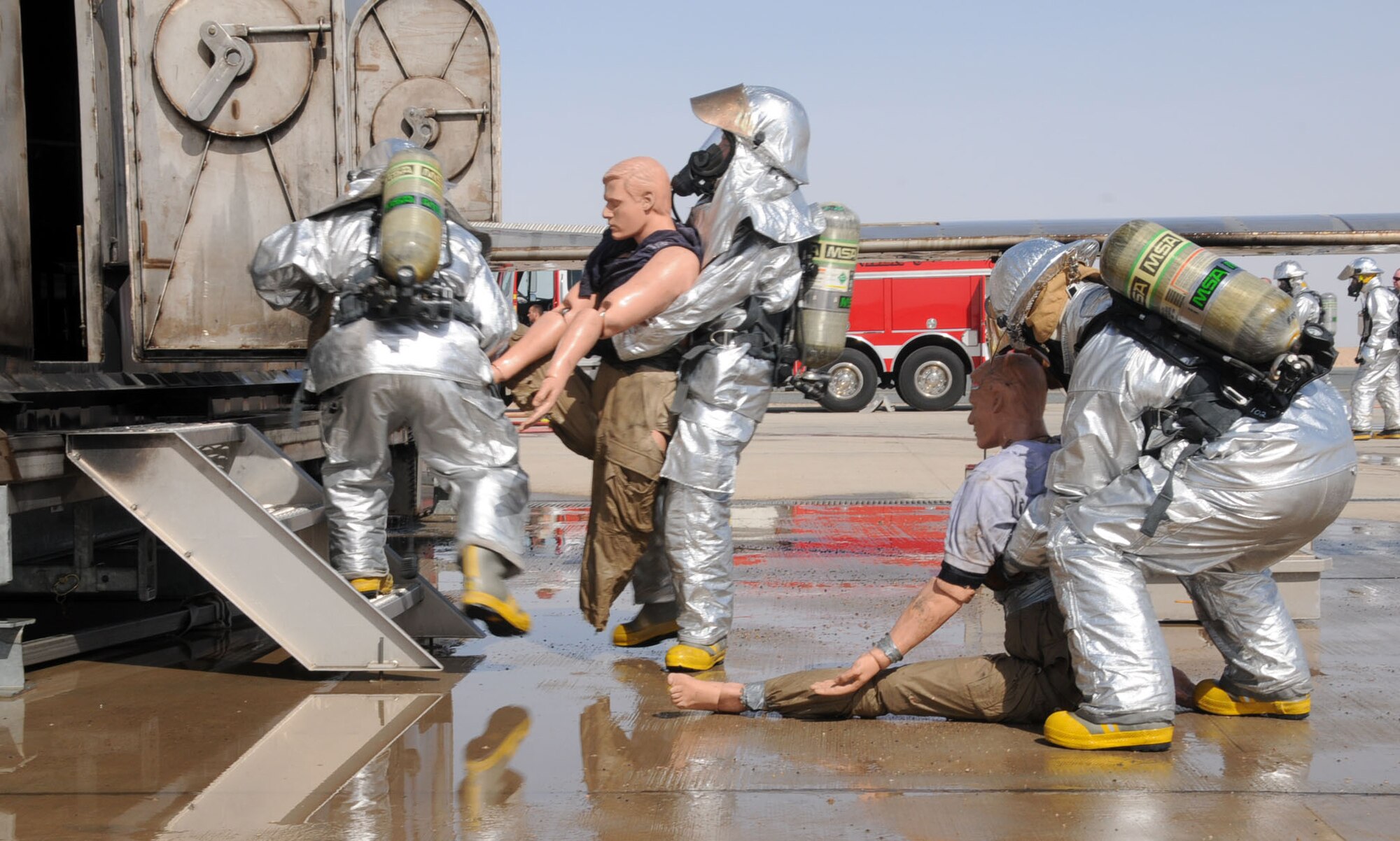 U.S. Air Force firefighters from the 386th Expeditionary Civil Engineering Squadron conduct aircraft rescue and fire fighting (ARFF) on an aircraft fire simulator on a flightline in an undisclosed location, Southwest Asia, Feb. 14, 2012. The 386th ECES firefighters were required to simulate extinguishing a structural fire and extract personnel to refresh their skills needed to perform in an emergency situation. (U.S. Air Force photo by Staff Sgt. James Lieth/Released)