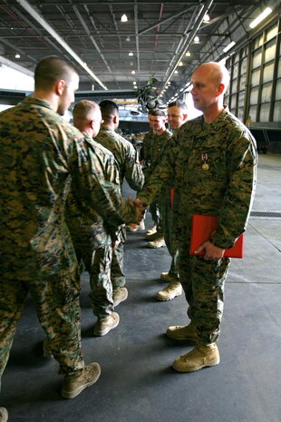 Marines from Marine Medium Tiltrotor Squadron 264 congratulate (From right to left) Capt. Thomas M. Keech, pilot, Capt. Matthew A. Cave, co-pilot, Sgt. Justin K. Bartfield-Smith, aerial gunner and observer, and Cpl. John M. Cederholm, crew chief, after they were awarded the Air Medal, Dec. 16. The award was presented for the crew’s conduct during a priority re-supply mission in support of 1st Battalion, 5th Marine Regiment, in the Sangin River Valley, Afghanistan, June, 12. This mission was the first time an MV-22B had engaged an enemy in Afghanistan.