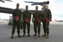 Marines from Marine Medium Tiltrotor Squadron 264 were awarded the Air Medal for heroic actions in support of Operation Enduring Freedom, Dec. 16. (From left to right) Cpl. John M. Cederholm, the mission crew chief, Sgt. Justin K. Bartfield-Smith, the mission aerial gunner and observer, Capt. Matthew A. Cave, the mission co-pilot, and Capt. Thomas M. Keech, the mission pilot, were recognized for actions during a priority re-supply mission in support of 1st Battalion, 5th Marine Regiment, in the Sangin River Valley, Afghanistan, June, 12. This mission was the first time an MV-22B had engaged an enemy in Afghanistan.