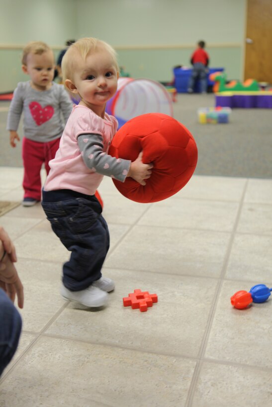 A child plays with a ball at Midway Park's Community Play Date Dec. 20. Community Play Date is a weekly event where children under two can play in an unstructured environment. (Official U.S. Marine Corps Photo by Pfc. Jackeline M. Perez Rivera) 