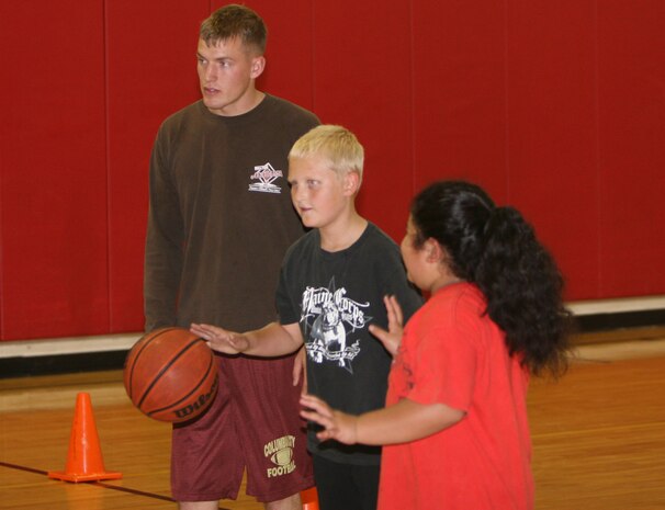 Lance Cpl. Justin A. Swaidner, an aviation ordnance technician with Headquarters and Headquarters Squadron aboard Marine Corps Air Station New River teaches basketball fundamentals to a youth basketball team he coaches. The basketball team consists of six and seven year old children.