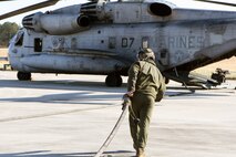 Cpl. Theodore M. Young, a crew chief, brings back the fuel line after refueling an AH-1W Cobra. Marines with Marine Heavy Helicopter Squadron 461 conducted training setting up a Forward Arming and Refueling Point at Blackstone Army Airfield, Dec. 13.