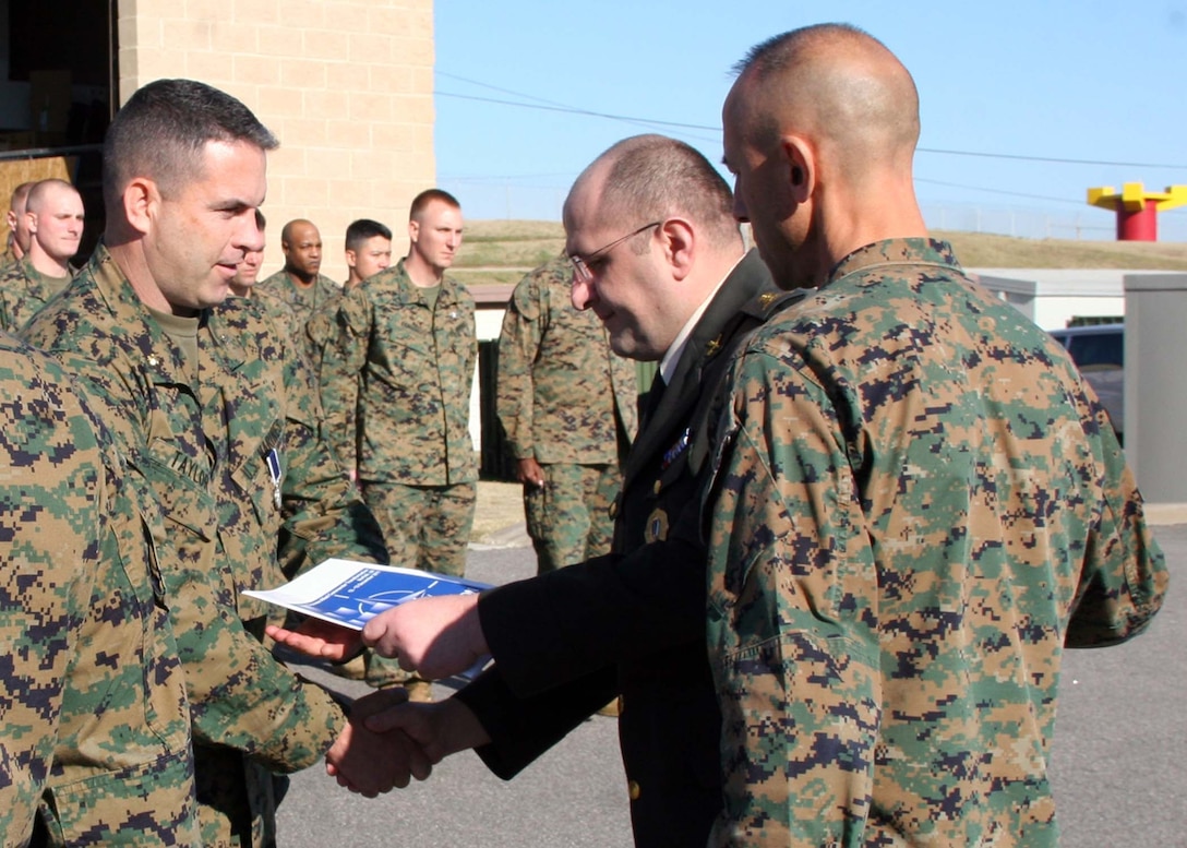 Maj. Stephen J. Taylor, commanding officer of Headquarters Battalion, 2nd Marine Division, Camp Lejeune, N.C., receives the Republic of Georgia Ministry of Defense Award from Georgian Lt. Col. Lasha Beridze, deputy chief of defense, Republic of Georgia Ministry of Defense, during a ceremony at Marine Corps Security Cooperation Group, Virginia Beach, Va., on Dec. 13, 2011. Taylor received the award "for outstanding support and dedication which contributed greatly to the overall success of the 3rd Georgian Brigade's mission in Afghanistan" from February to August 2011 while deployed to Afghanistan with Regimental Combat Team 2.